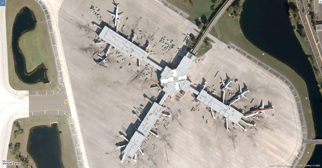 Past Projects: An aerial view of an airport with planes parked on the ground.