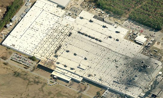An aerial view of a large factory, showcasing its past projects.
